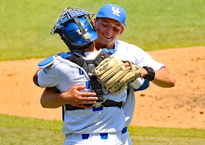Kentucky catcher Devin Burkes embraced pitcher Mason Moore after Moore closed out Friday's 4-0 win over Ball State with five perfect innings of relief work.