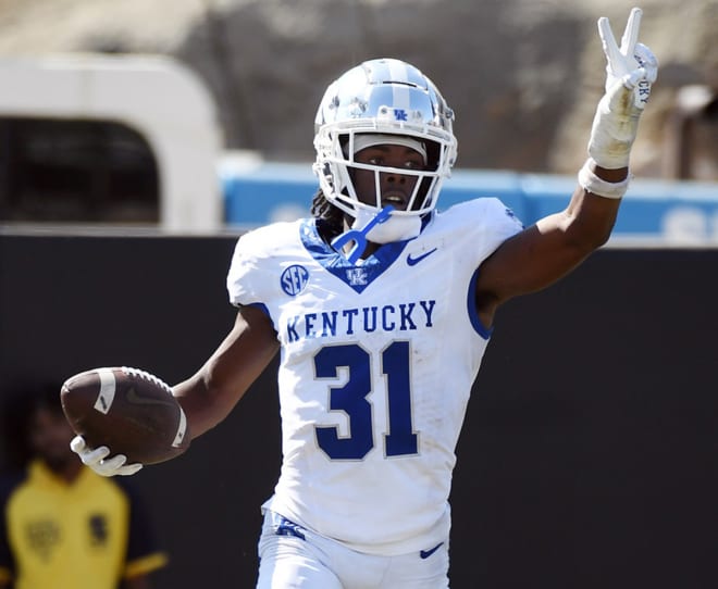 Kentucky cornerback Maxwell Hairston signals two to his teammates after his second interception return for a touchdown on Saturday in the Wildcats' 45-28 win at Vanderbilt. 