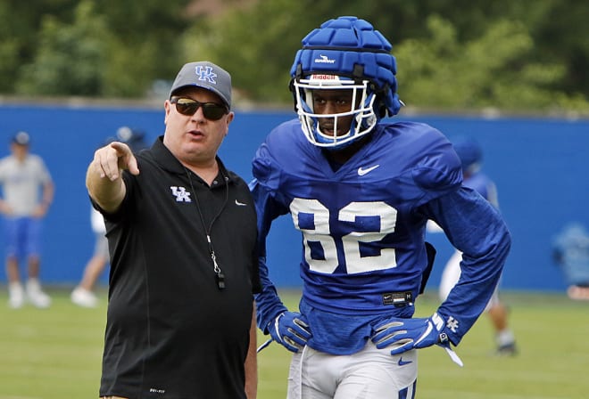 Mark Stoops worked with receiver Tae Tae Crumes during a recent UK football practice.