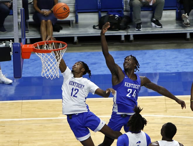 Transfer guard Antonio Reeves (12) drove to the basket against freshman wing Chris Livingston during Kentucky's open practice/flood relief telethon on Tuesday night at Rupp Arena.