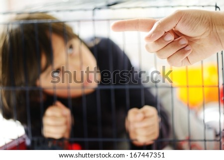 stock-photo-kid-in-cage-prisoned-167447351.jpg