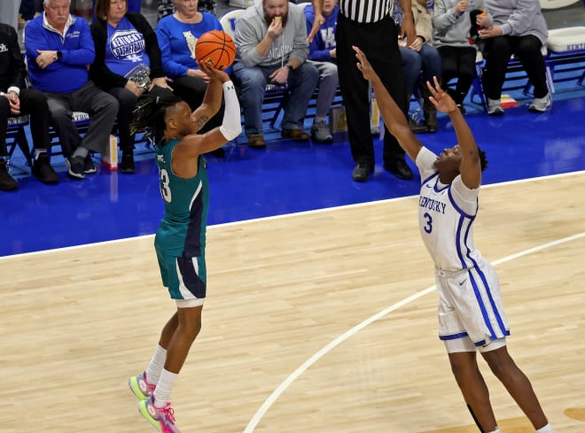 UNC-Wilmington's Trazarien White knocked down a 3-pointer en route to his game-high 27 points in an 80-73 upset of No. 12 Kentucky on Saturday at Rupp Arena. 