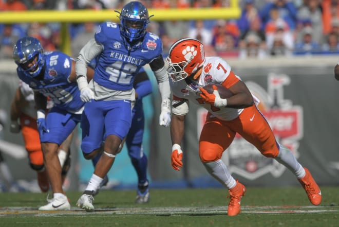 Clemson's Phil Mafah tried to elude Kentucky linebacker Tyrese Fearbry (42) during Friday's Gator Bowl in Jacksonville. 