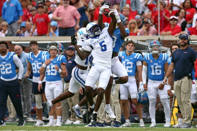 Kentucky defensive backs DJ Waller (5) and Ty Bryant (14) break up an Ole Miss pass during Saturday's game in Oxford, Miss.