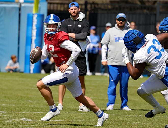 Kaiya Sheron (12) rolled out of the pocket during Saturday's open spring practice session at the Joe Craft Football Training Center.