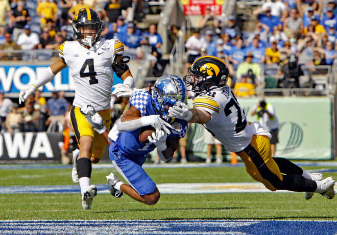 Kentucky's Wan'Dale Robinson made a diving catch between two Iowa defenders to convert a third-and-long play on Saturday in the Citrus Bowl.