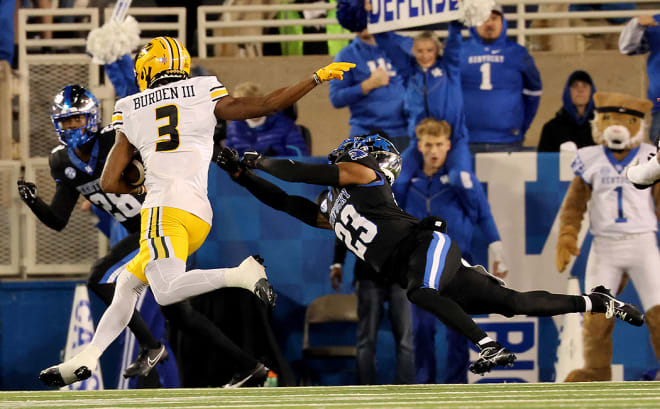 Missouri's Luther Burden III eluded the tackle of Kentucky defensive back Andru Phillips (23) during Saturday's game at Kroger Field. 