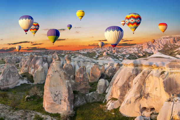 hot-air-balloons-at-sunset-over-the-cave-town-cappadocia-turkey.jpg