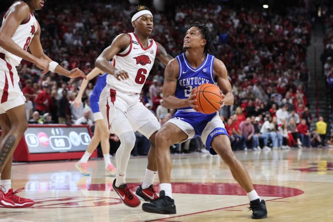 Kentucky's DJ Wagner looked for an opening around Arkansas guard Layden Blocker during Saturday's game at Bud Walton Arena.