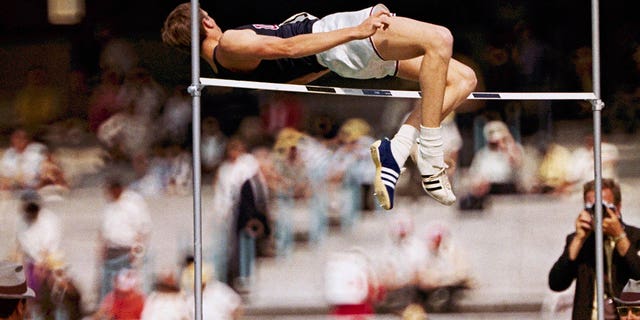 FILE - Dick Fosbury, of the United States, clears the bar in the high jump competition at the 1968 Mexico City Olympics.