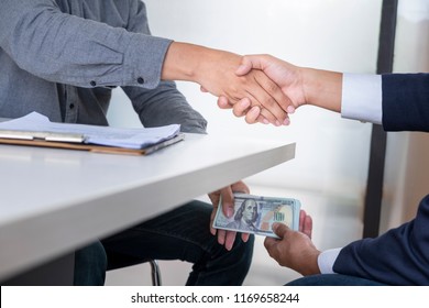 hands-passing-money-under-table-260nw-1169658244.jpg